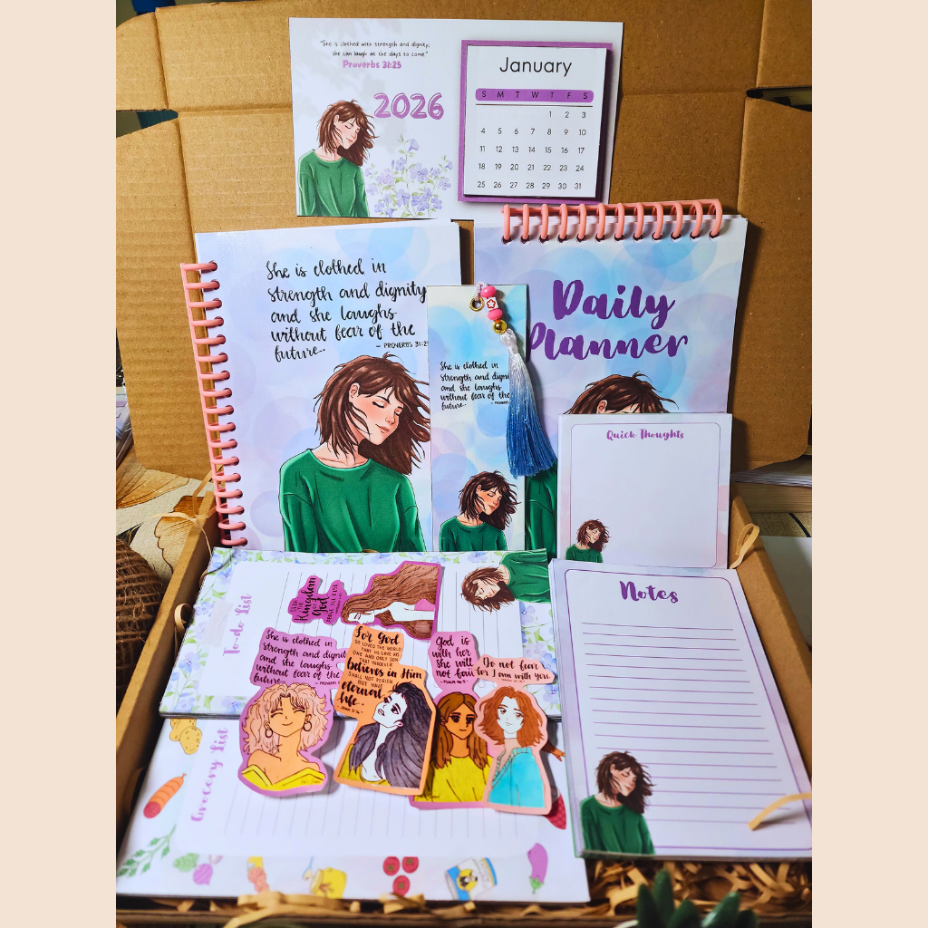 Collection of planners and calendars with illustrated designs on a wooden surface.