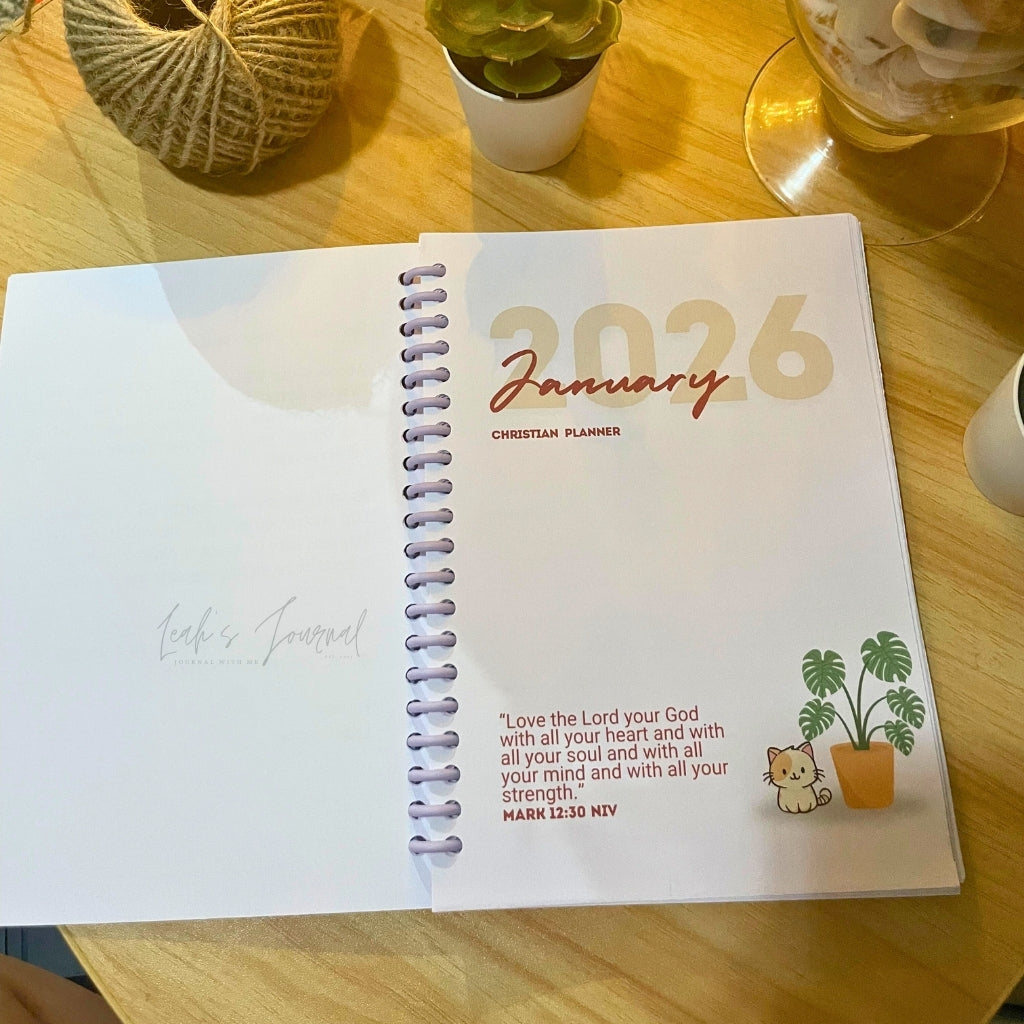 2026 planner with January page on a wooden table