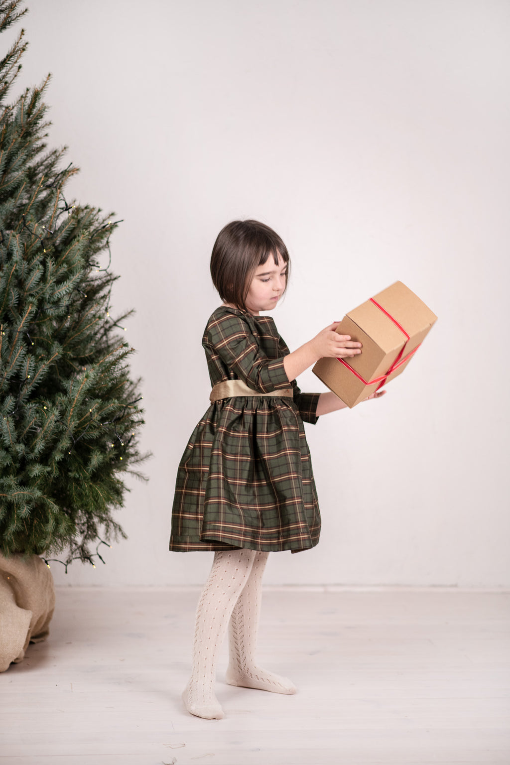 Open spiral-bound notebook with mood and ministry trackers on a wooden surface with plants.